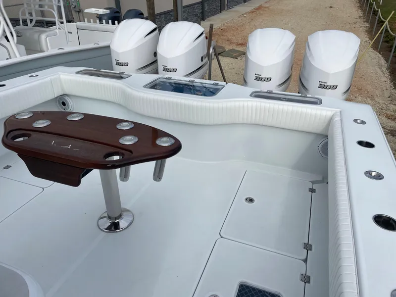 Slide: The Image of 2019 Freeman 37 boat with four powerful outboard engines and a sleek fishing setup. - 25