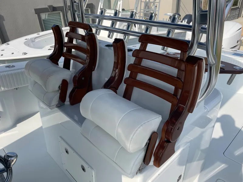 Slide: The Image of Luxury seating on a 2019 Freeman 37 boat with wooden accents and white cushions. - 26