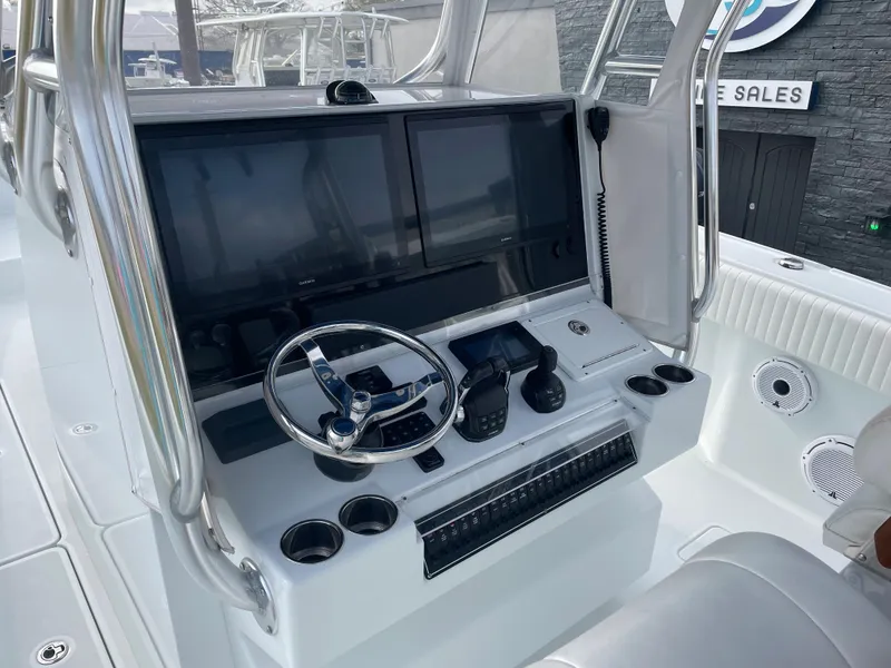 Slide: The Image of 2019 Freeman 37 boat dashboard with dual screens and steering wheel. - 28