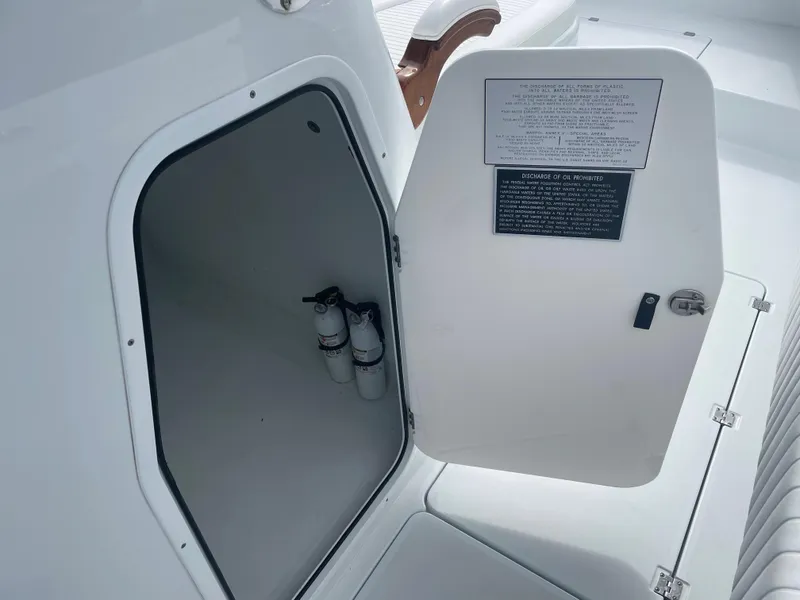 Slide: The Image of Open storage compartment on a 2019 Freeman 37 boat with fire extinguishers inside. - 30