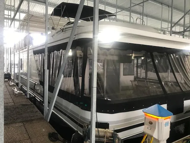 Slide: The Image of 2002 Sumerset Houseboat docked in a covered marina. - 1