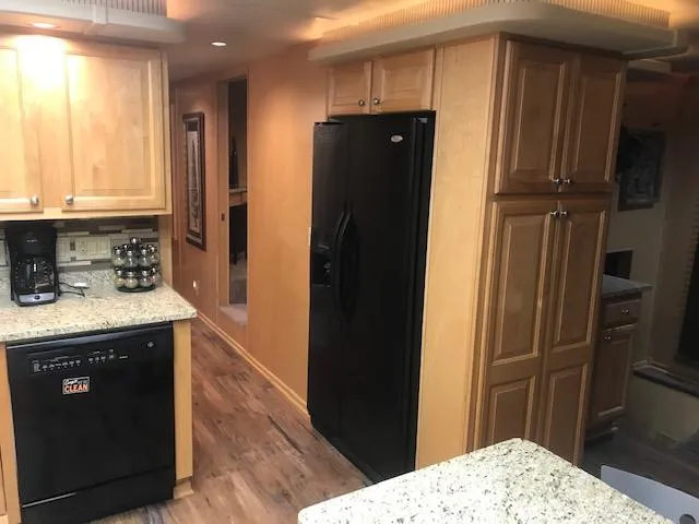 Slide: The Image of Modern kitchen interior of 2002 Sumerset Houseboat with granite countertops and wooden cabinets. - 12