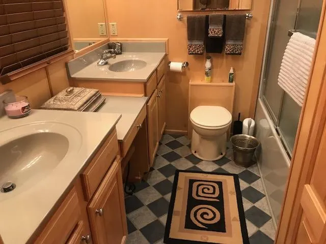 Slide: The Image of 2002 Sumerset Houseboat bathroom with dual sinks, toilet, and shower. - 13