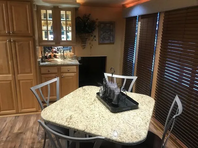 Slide: The Image of Modern kitchen interior of 2002 Sumerset Houseboat with granite countertops and wooden cabinets. - 14
