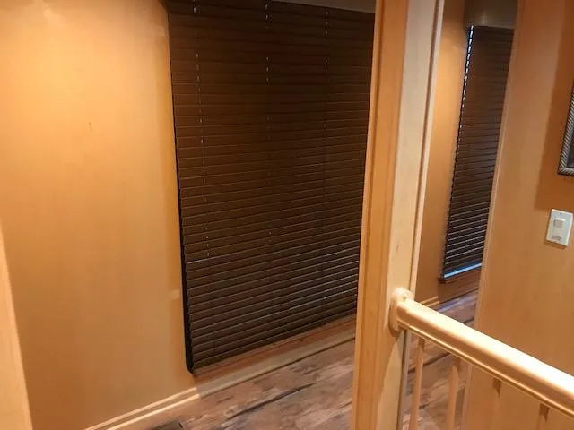 Slide: The Image of Interior hallway of a 2002 Sumerset Houseboat with wooden blinds and flooring. - 16