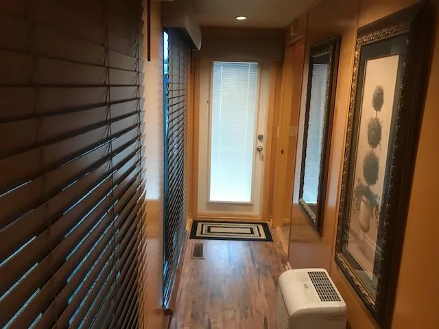 Slide: The Image of Interior hallway of a 2002 Sumerset Houseboat with wooden blinds and framed artwork. - 17