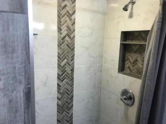 Slide: The Image of Modern shower in 2002 Sumerset Houseboat with herringbone tile accent. - 20