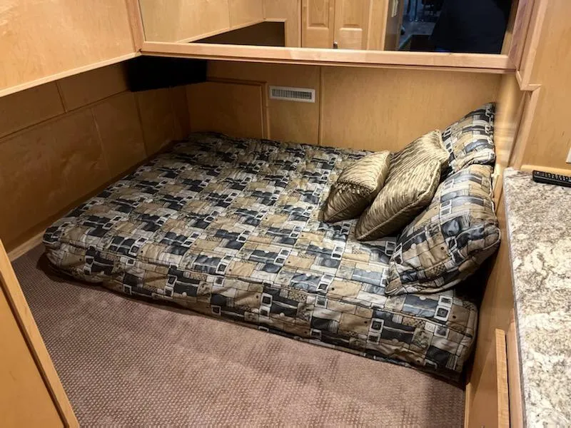Slide: The Image of 2002 Sumerset Houseboat cozy bedroom with patterned bedding and pillows. - 26