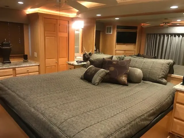 Slide: The Image of Luxurious bedroom interior of a 2002 Sumerset Houseboat with a large bed and modern decor. - 29
