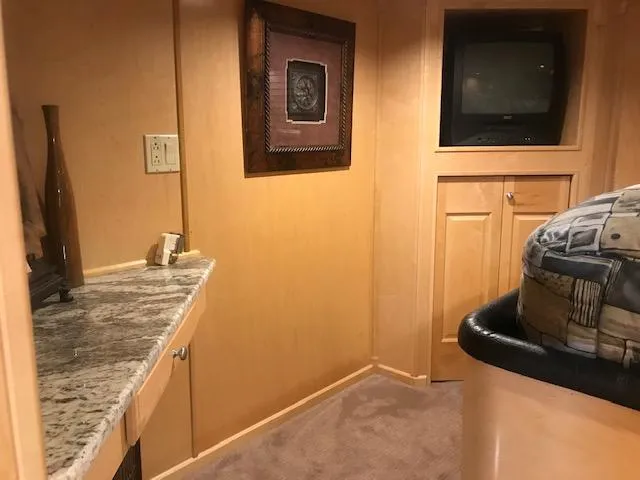 Slide: The Image of Interior of a 2002 Sumerset Houseboat with granite countertop and TV. - 34