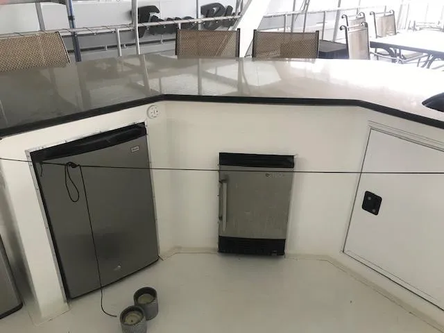 Slide: The Image of 2002 Sumerset Houseboat interior with mini fridge and storage. - 38