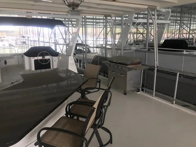 Slide: The Image of Upper deck of a 2002 Sumerset Houseboat with seating and grill. - 40