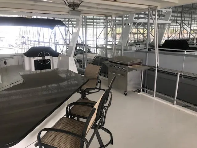 Slide: The Image of 2002 Sumerset Houseboat with outdoor seating and grill on deck. - 41