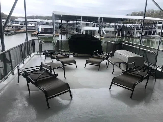 Slide: The Image of Upper deck of a 2002 Sumerset Houseboat with lounge chairs and a grill. - 43