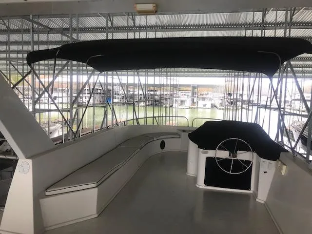 Slide: The Image of 2002 Sumerset Houseboat helm with seating area under covered dock. - 46