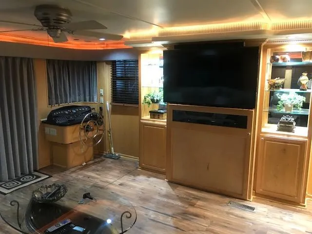 Slide: The Image of Interior of a 2002 Sumerset Houseboat with modern amenities and wooden decor. - 6