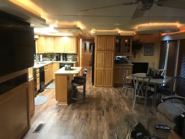 Slide: The Image of Interior of a 2002 Sumerset Houseboat with modern kitchen and dining area. - 7