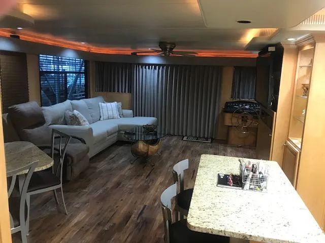 Slide: The Image of Luxurious 2002 Sumerset Houseboat interior with modern furnishings and wood flooring. - 8