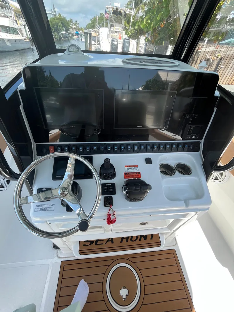 Slide: The Image of 2020 Sea Hunt 30 Gamefish helm with dual screens and steering wheel. - 14