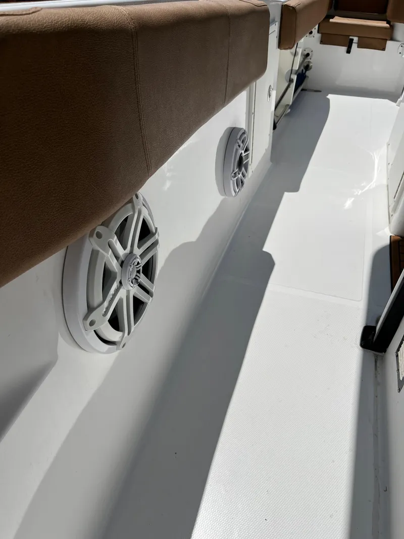 Slide: The Image of 2020 Sea Hunt 30 Gamefish boat interior with speakers and cushioned seating. - 18