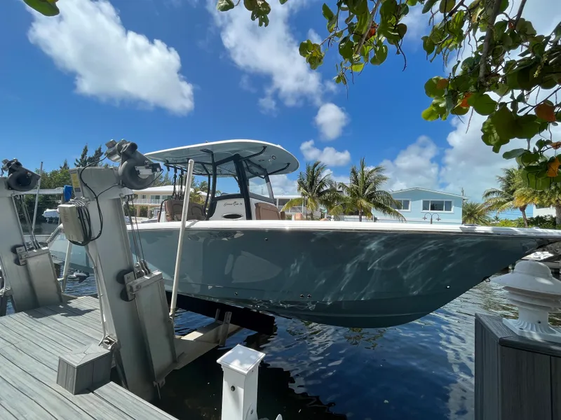 Slide: The Image of 2020 Sea Hunt 30 Gamefish boat docked under a sunny sky. - 5