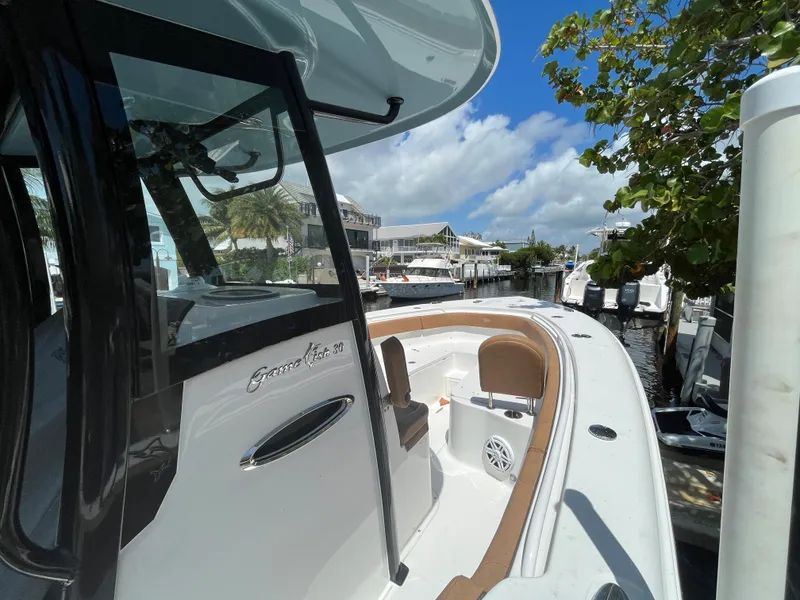 Slide: The Image of 2020 Sea Hunt 30 Gamefish boat docked under a clear blue sky. - 7