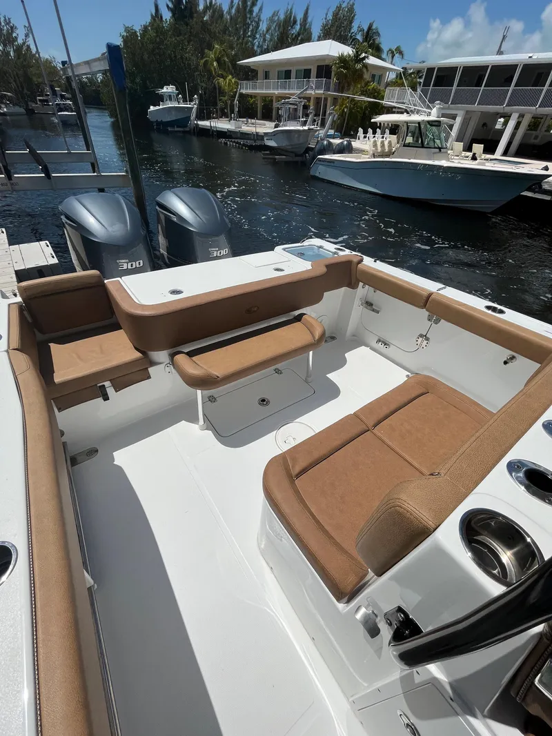 Slide: The Image of 2020 Sea Hunt 30 Gamefish boat interior with tan seating and dual engines. - 9