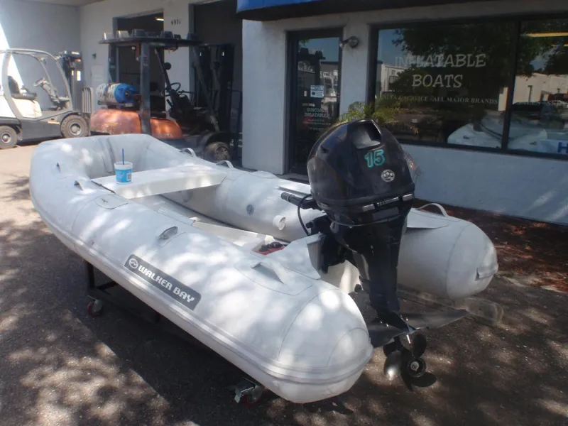 Slide: The Image of 2016 Walker Bay Odyssey 310 SLRX inflatable boat with outboard motor. - 2