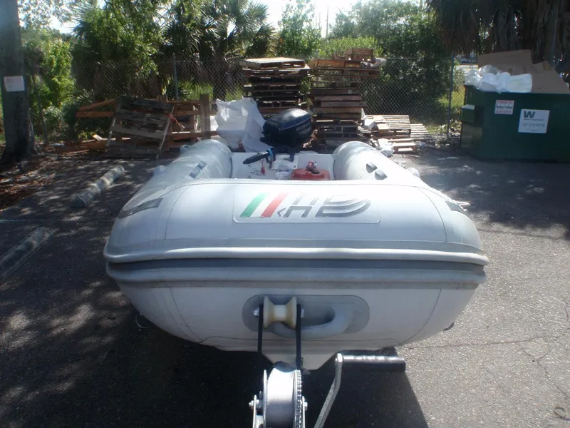 Slide: The Image of 2004 AB Inflatables Navigo 3.20VS inflatable boat on trailer in outdoor storage area. - 2