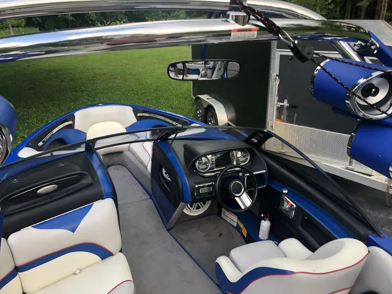 Slide: The Image of Interior of a 2013 Malibu Wakesetter VLX boat with blue and white seating. - 2