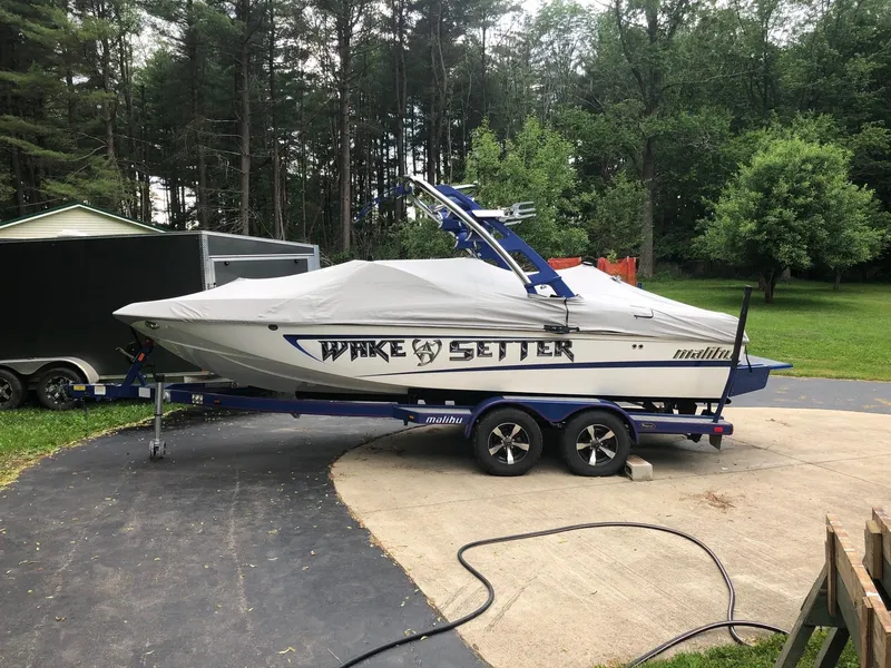 Slide: The Image of 2013 Malibu Wakesetter VLX boat on trailer with cover in driveway. - 3