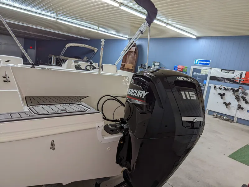 Slide: The Image of 2023 Starcraft SVX 171 OB boat with Mercury 115 outboard motor in showroom. - 11