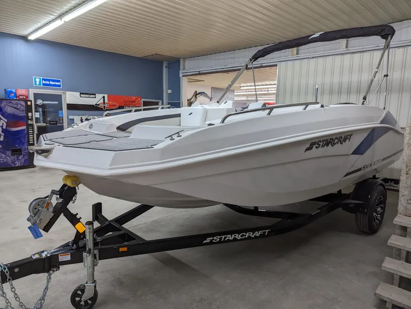 Slide: The Image of 2023 Starcraft SVX 171 OB boat on a trailer in a showroom. - 2