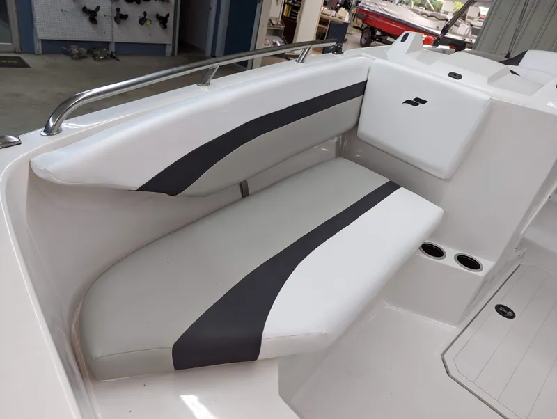 Slide: The Image of 2023 Starcraft SVX 171 OB boat interior seating with white and gray upholstery. - 7