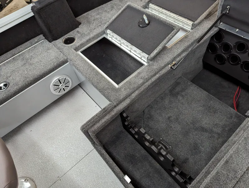 Slide: The Image of 2023 Smoker Craft Adventurer 188 T boat interior with storage compartments and speaker. - 11