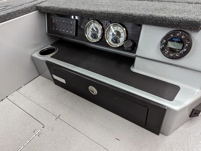 Slide: The Image of 2023 Smoker Craft Adventurer 188 T dashboard with gauges and storage compartment. - 6
