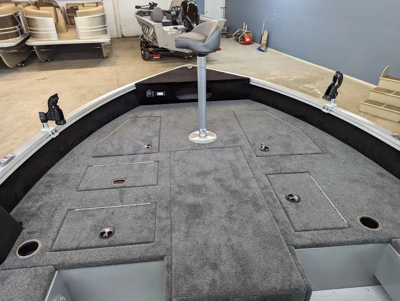 Slide: The Image of 2023 Smoker Craft Adventurer 188 T boat interior with gray carpet and seating. - 8