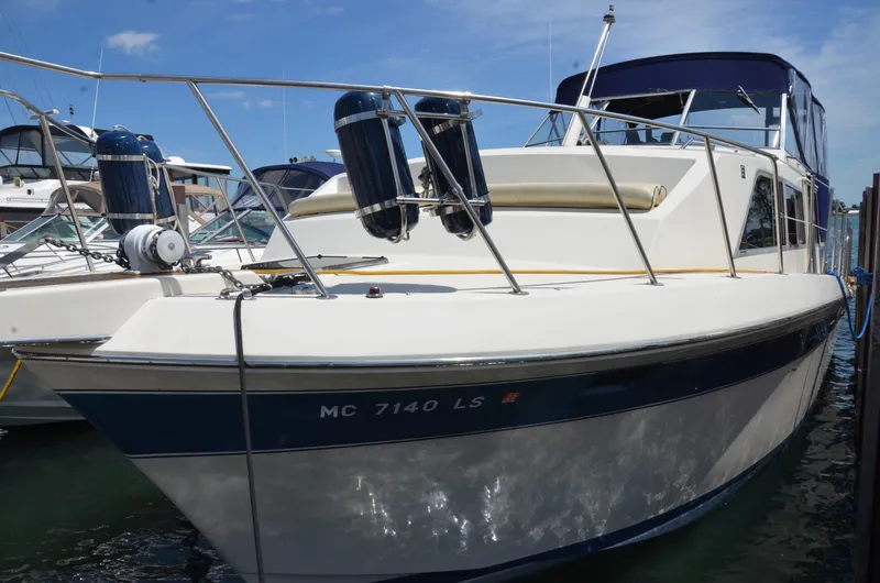 The Image of 1984 Chris-Craft 381 Catalina boat docked, featuring sleek design and blue accents. - 0