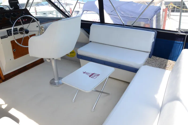 Slide: The Image of 1984 Chris-Craft 381 Catalina interior with helm, seating, and table. - 11