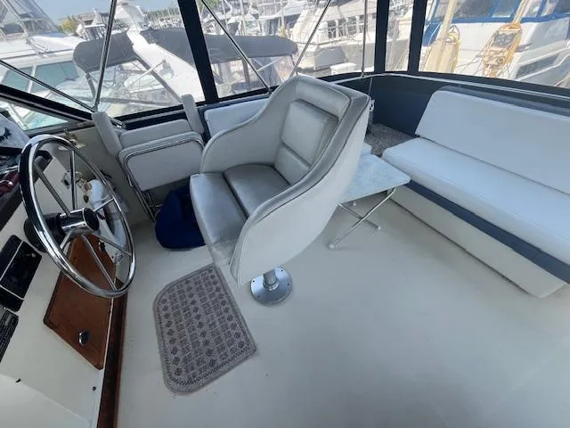 Slide: The Image of 1984 Chris-Craft 381 Catalina interior with helm, seating, and steering wheel. - 12