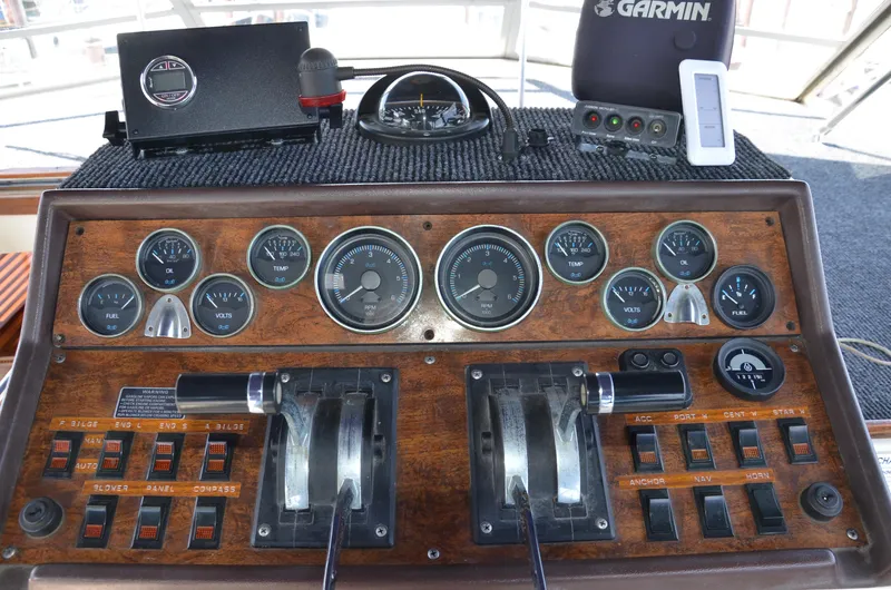 Slide: The Image of 1984 Chris-Craft 381 Catalina dashboard with gauges, controls, and Garmin navigation equipment. - 14