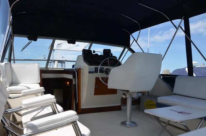 Slide: The Image of 1984 Chris-Craft 381 Catalina boat interior with helm, seating, and canopy. - 17