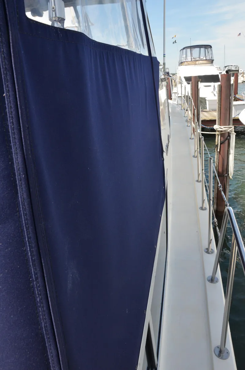Slide: The Image of 1984 Chris-Craft 381 Catalina yacht with blue canvas cover docked at marina. - 18
