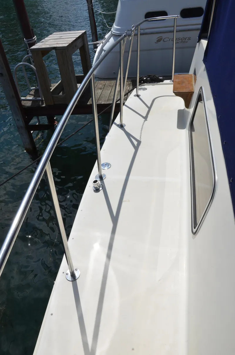 Slide: The Image of 1984 Chris-Craft 381 Catalina yacht deck with railing, docked by the water. - 19