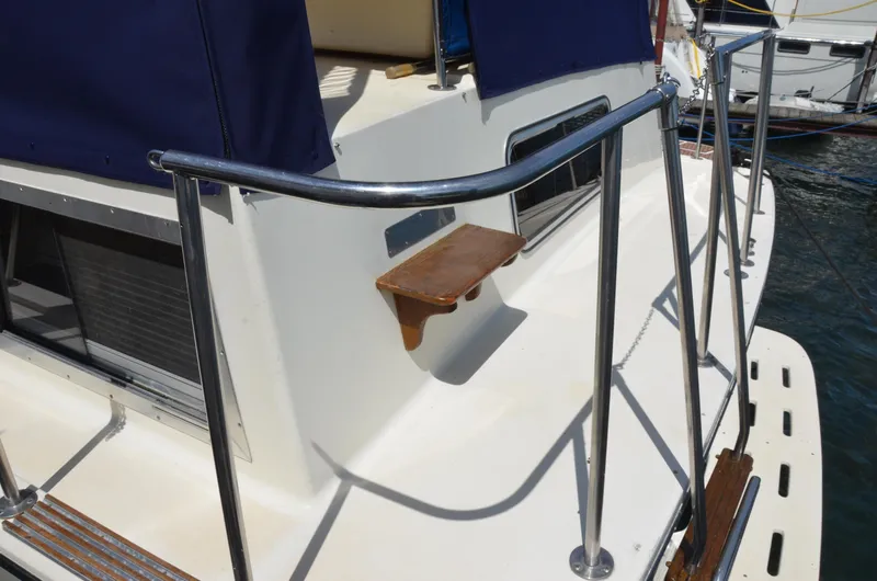 Slide: The Image of 1984 Chris-Craft 381 Catalina yacht deck with railing and wooden seat. - 20