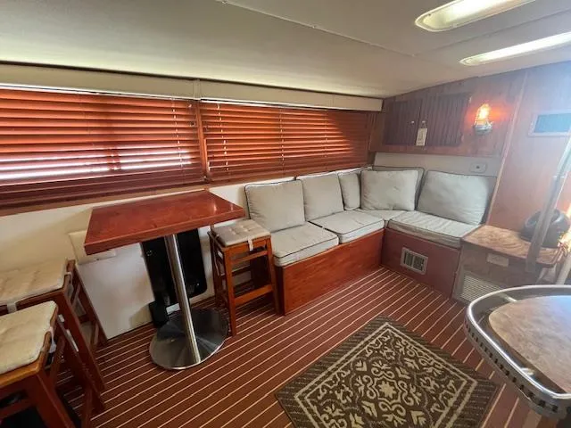 Slide: The Image of Interior of 1984 Chris-Craft 381 Catalina with wood accents and cozy seating area. - 25