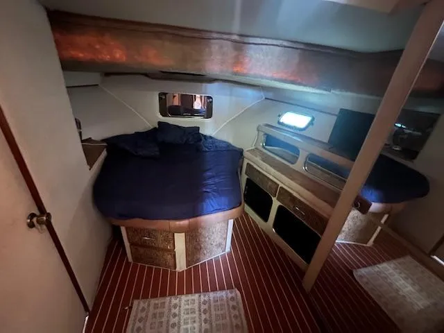 Slide: The Image of Interior of 1984 Chris-Craft 381 Catalina yacht with cozy sleeping area and wooden accents. - 31