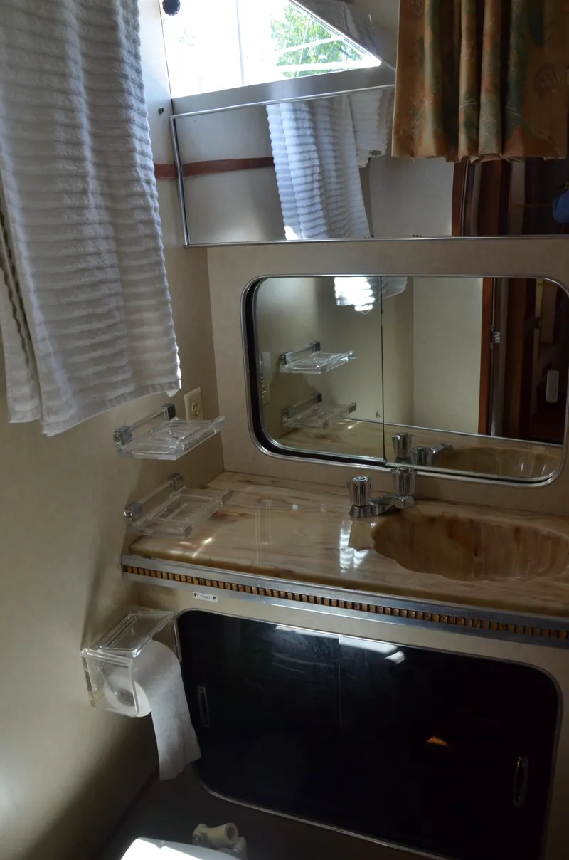 Slide: The Image of 1984 Chris-Craft 381 Catalina bathroom with mirror, sink, and window. - 32