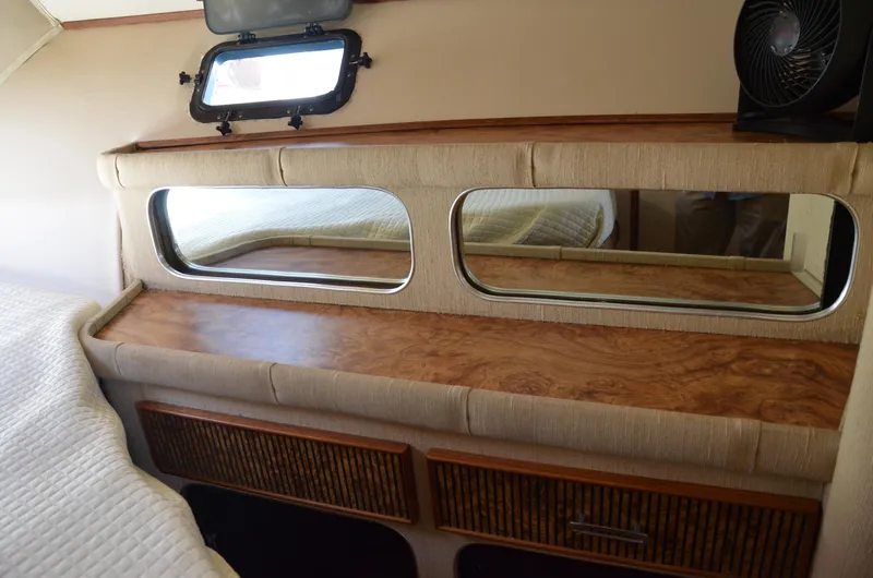 Slide: The Image of 1984 Chris-Craft 381 Catalina cabin interior with wood accents and dual mirrors. - 33