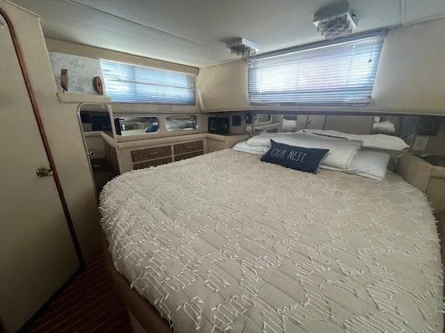 Slide: The Image of 1984 Chris-Craft 381 Catalina bedroom with cozy bed and nautical decor. - 38